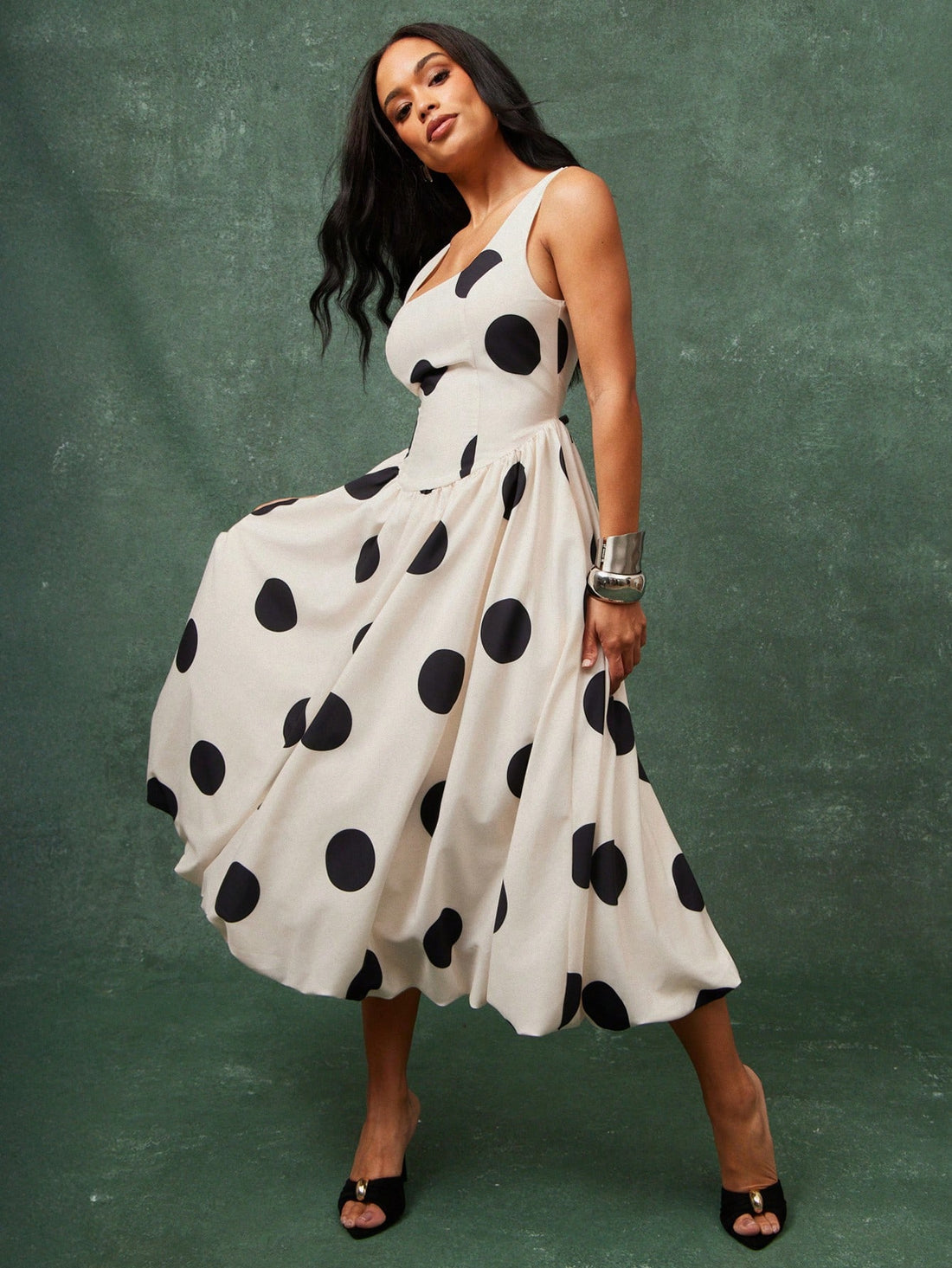 Turn heads with this charming polka dot midi dress that effortlessly blends vintage-inspired style with modern flair. The voluminous puff sleeves add a playful touch, while the bubble hem creates a fun, dimensional silhouette that moves beautifully. Perfect for brunch dates, garden parties, or any occasion where you want to make a statement. Dress it up with heels or keep it casual with sneakers—this versatile piece adapts to your mood and makes getting dressed an absolute joy.
