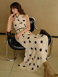 Turn heads with this playful polka dot halter dress featuring a flattering mermaid hem. Its chic print and elegant silhouette make it perfect for effortless style at any event. Feel confident and fun while embracing timeless charm.