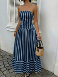 Front view of navy blue striped strapless maxi dress with gathered skirt