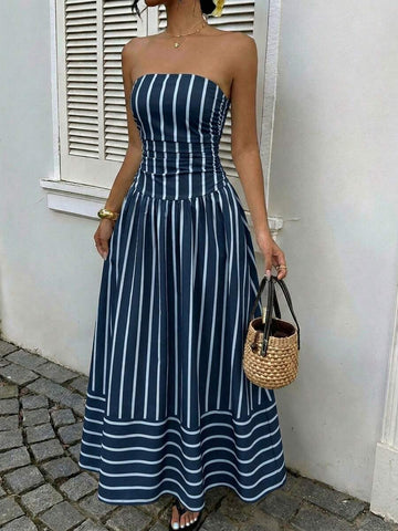 Front view of navy blue striped strapless maxi dress with gathered skirt