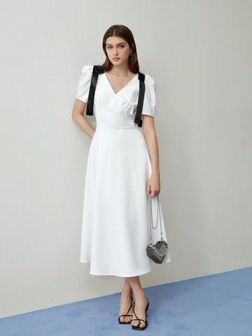 Step into spring with this playful puff sleeve dress, featuring a charming bow detail that adds a flirty touch perfect for Valentine's Day or sunny days ahead. Its light, breezy design keeps you comfortable while turning heads wherever you go. Embrace effortless style and a fun, feminine vibe all season long.