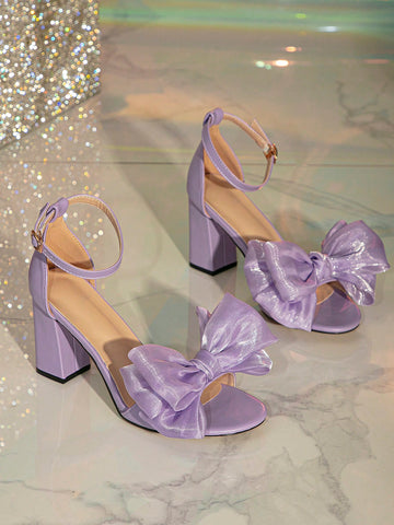 Step up your shoe game with these chic and playful purple sandals adorned with a cute bow detail. Designed with a chunky heel and ankle strap, these sandals not only add a pop of color to your outfit, but also provide comfort and support for all-day wear. Perfect for any stylish woman!