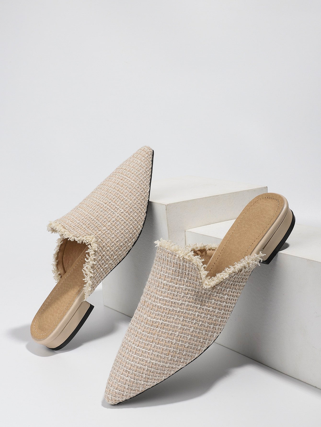 Discover effortless style with our chic raw trim pointed toe flat mules. The pointed toe design adds a touch of sophistication while the raw trim detailing completes the look with an effortlessly chic vibe. These mules are the perfect addition to any outfit, providing both comfort and style.