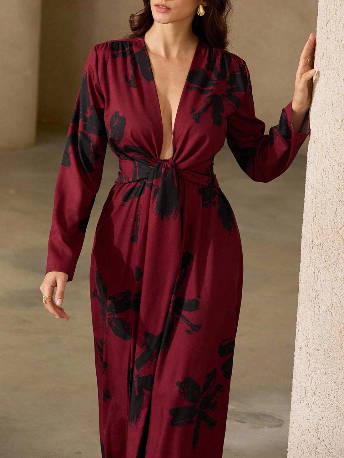Make a statement in this playful red and black floral maxi dress designed to turn heads. Its deep V-neck adds a flirty touch, while the tie knot detail cinches your waist for a flattering fit. Flowing fabric keeps you comfortable and effortlessly chic, perfect for sunny days or evening fun.