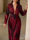 Make a statement in this playful red and black floral maxi dress designed to turn heads. Its deep V-neck adds a flirty touch, while the tie knot detail cinches your waist for a flattering fit. Flowing fabric keeps you comfortable and effortlessly chic, perfect for sunny days or evening fun.