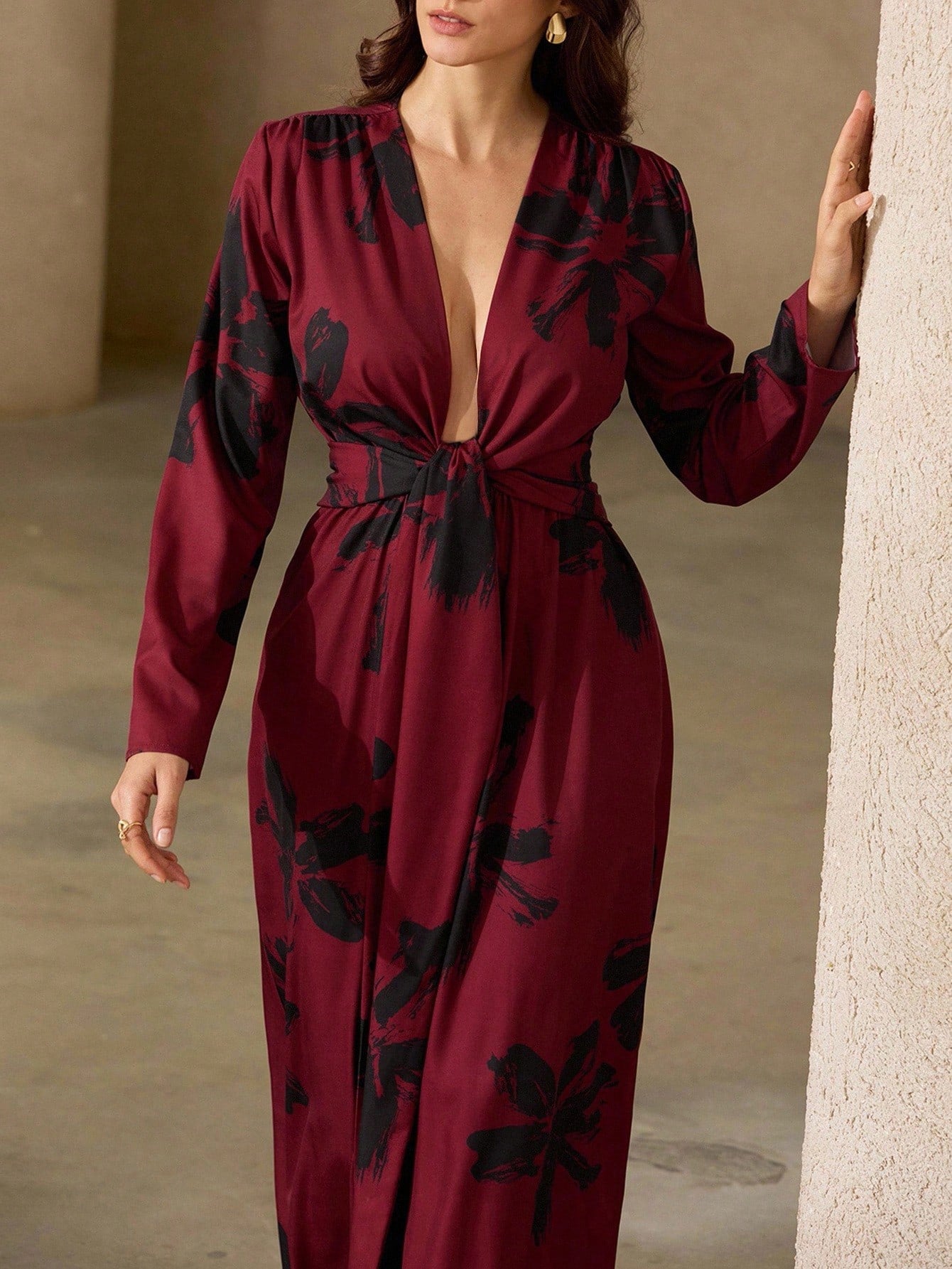Make a statement in this playful red and black floral maxi dress designed to turn heads. Its deep V-neck adds a flirty touch, while the tie knot detail cinches your waist for a flattering fit. Flowing fabric keeps you comfortable and effortlessly chic, perfect for sunny days or evening fun.