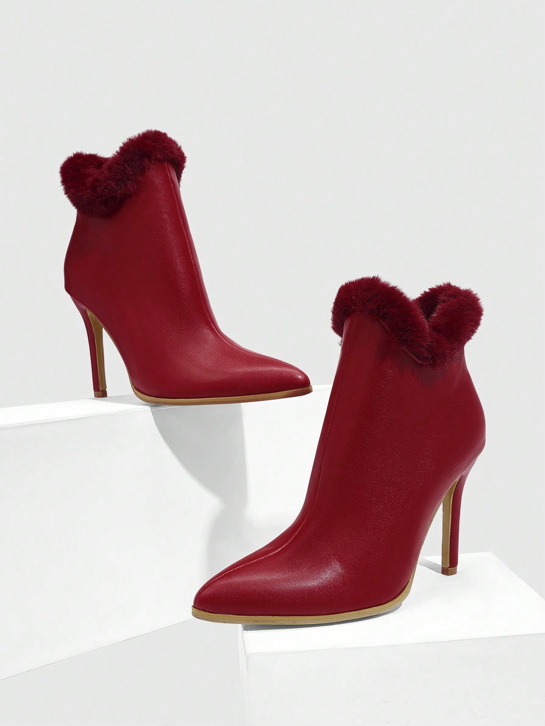 Elevate your style with our Chic Red High Heel Ankle Boots with Faux Fur Accents! The bold red color and faux fur accents will add a touch of luxury to any outfit. Step out in confidence and make a statement with these chic and fashion-forward boots. Perfect for any occasion, these boots will keep you looking and feeling your best!
