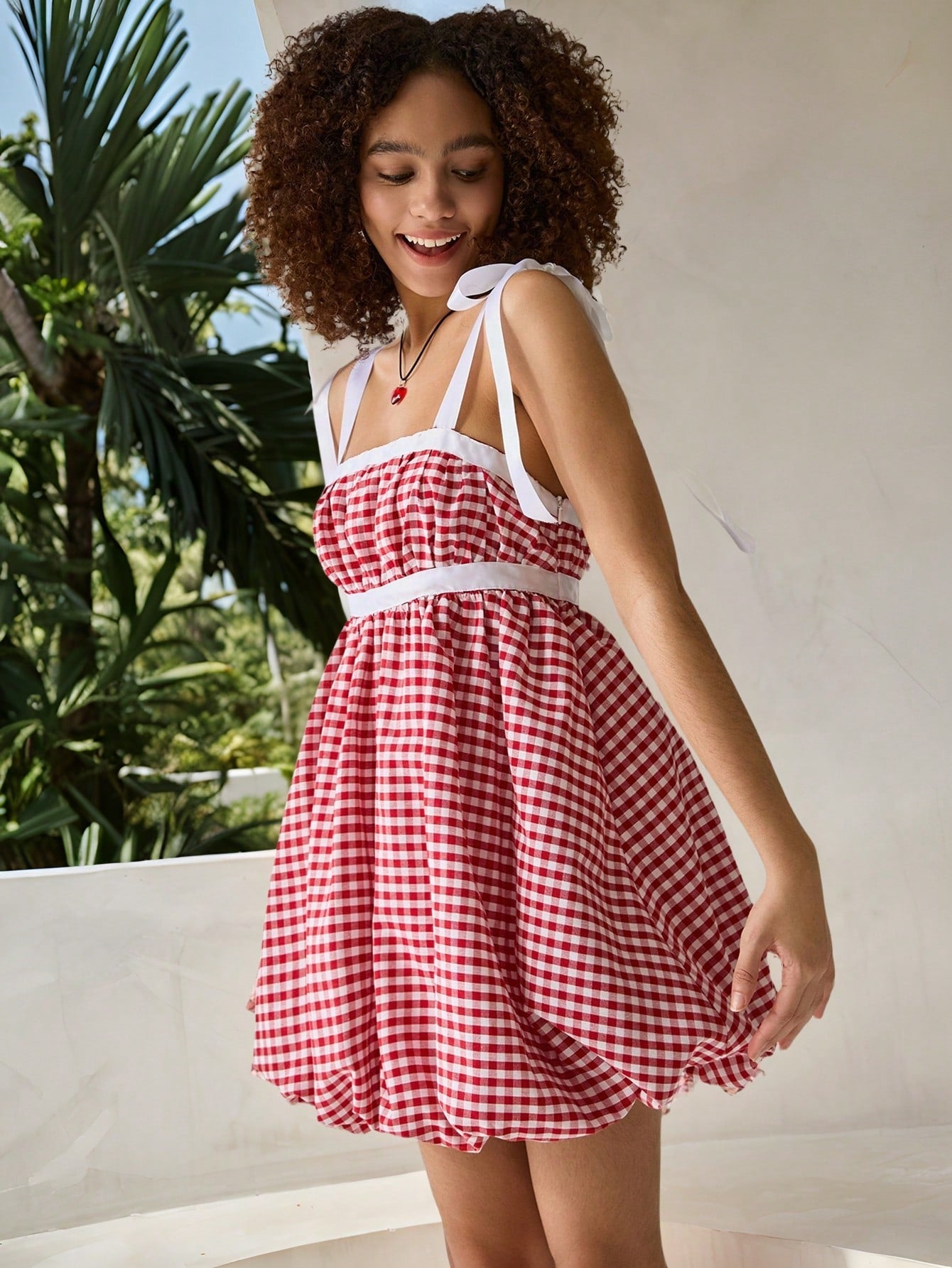 Step into sunshine with this playful red and white checkered mini dress, designed to brighten your spring and summer getaways. Featuring a charming bow knot detail, it adds a flirty touch to your vacation wardrobe. Lightweight and breezy, this dress keeps you comfortable while turning heads wherever you go. Perfect for picnics, beach strolls, or casual outings, it’s your go-to for effortless, fun style.