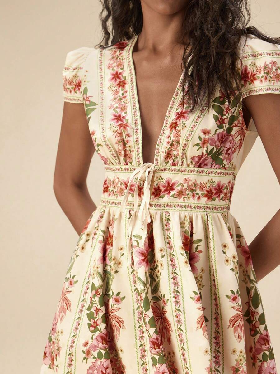Embrace effortless elegance with this chic retro printed dress, perfect for your next getaway. Featuring a flattering deep V-neckline, delicate ruffled puff sleeves, and a cinched high waist that defines your silhouette, this piece combines vintage charm with modern comfort. The A-line, fit-and-flare cut with a flared hem creates beautiful movement, while the botanical print in multicolor adds a playful boho touch. Crafted from a breathable woven fabric blend of 95% polyester and 5% elastane.