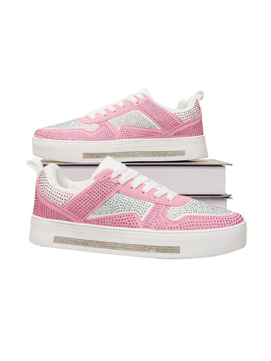 Side profile of pink rhinestone platform sneakers with white laces and crystal midsole strips