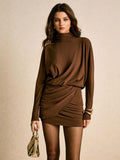 Slip into effortless elegance with this stunning ruched turtleneck mini dress. The fitted bodycon silhouette hugs your curves in all the right ways, while strategic ruching adds dimension and flatters your figure. Rich brown tones work beautifully for fall and winter, pairing perfectly with boots, tights, or statement jewelry. Whether you're heading to a party or a night out, this versatile piece delivers sophisticated style with a touch of playful edge. The cozy turtleneck keeps you warm while the mini len