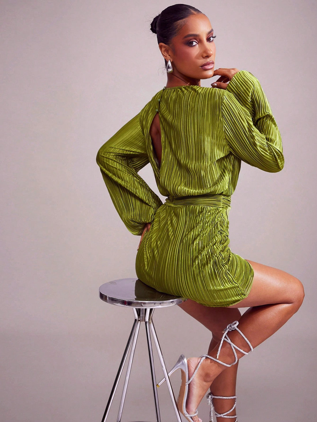 Get ready to turn heads in this Chic Satin Pleated Green Mini Dress! With a daring Plunge Neck and playful Tulip Hem, this dress is perfect for any festive occasion. Made from luxurious satin fabric, it's sure to make you feel chic and stylish. Make a statement and stand out from the crowd with this unique and fun mini dress.