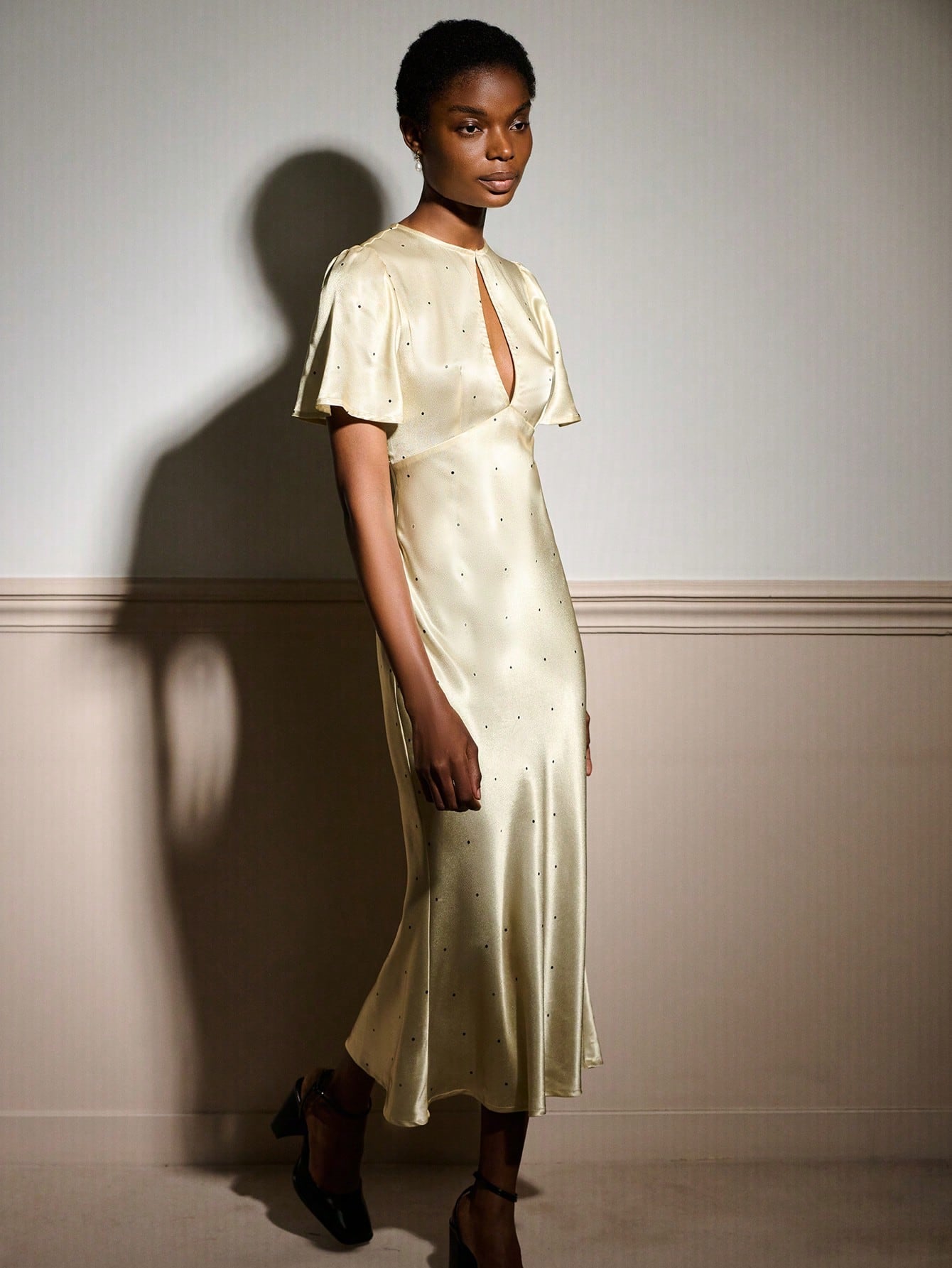 Slip into sophistication with this stunning butter yellow maxi dress that's equal parts glamorous and fun. The luxe satin fabric drapes beautifully while playful polka dots add a whimsical touch, and the cheeky keyhole detail at the neckline keeps things flirty. Whether you're heading to an elegant soirée or a romantic dinner, this dress strikes the perfect balance between timeless elegance and modern charm. Twirl, shine, and turn heads in a piece that feels as fabulous as you look.