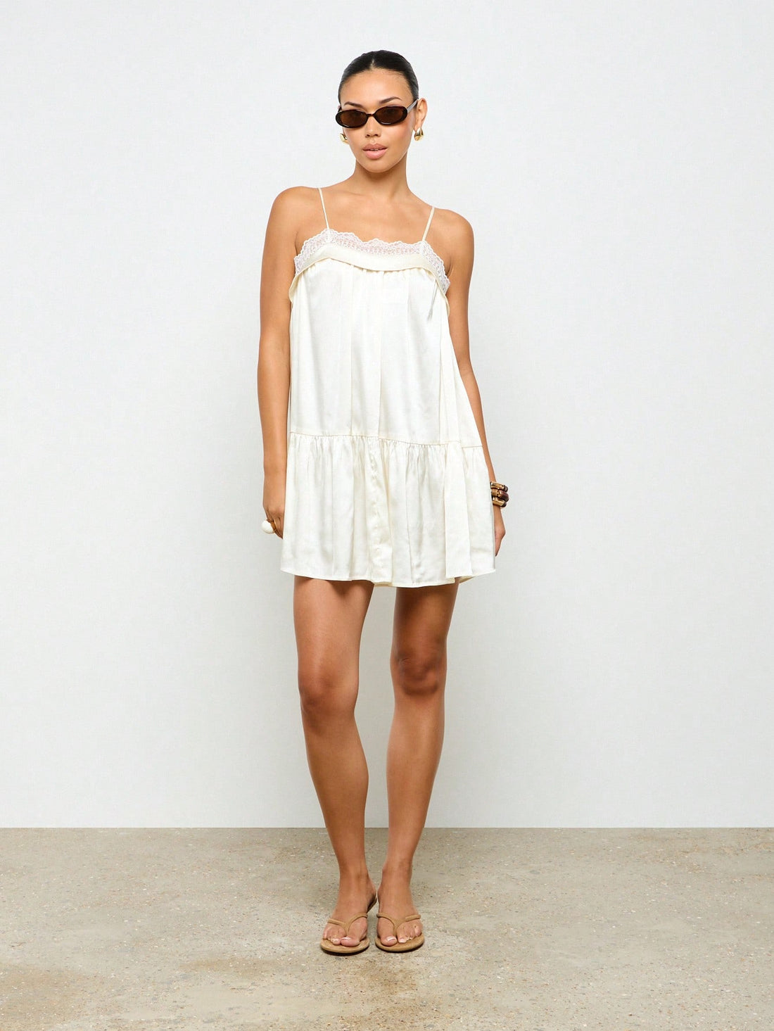 Turn heads effortlessly in this silky satin mini slip dress, featuring a flirty drop waist and delicate lace trim. Its lightweight, smooth fabric keeps you cool and comfy, making it your go-to for weddings, beach getaways, or laid-back summer parties. Embrace easy elegance with a playful twist!