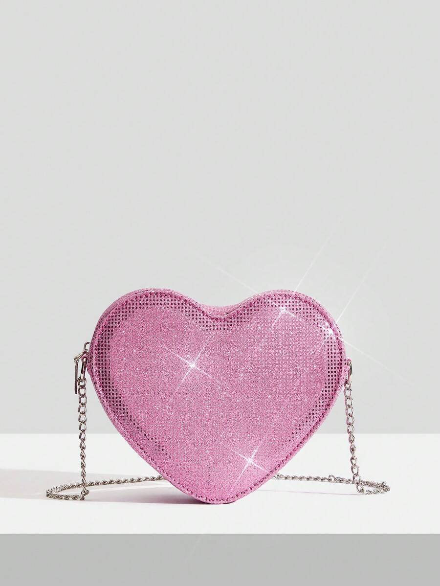 Add a touch of sparkle to your Valentine's Day outfit with this chic silver heart crossbody bag. Its sleek design and shimmering finish make it the perfect playful accessory to carry your essentials while turning heads. Lightweight and easy to wear, this bag effortlessly complements any look, adding a fun and flirty vibe to your special day.