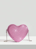 Add a touch of sparkle to your Valentine's Day outfit with this chic silver heart crossbody bag. Its sleek design and shimmering finish make it the perfect playful accessory to carry your essentials while turning heads. Lightweight and easy to wear, this bag effortlessly complements any look, adding a fun and flirty vibe to your special day.