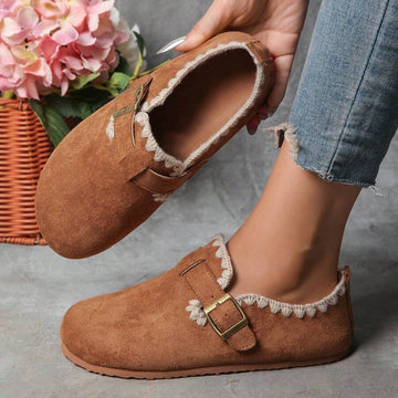 Close top view of camel suede-like loafers with cream lace trim and gold buckle