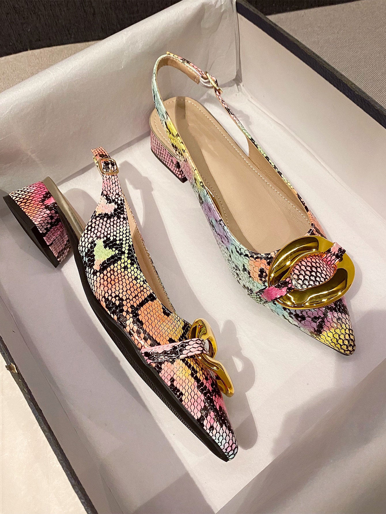 Elevate your style with these Chic Snakeskin Embossed Pointed Toe Slingback Flats. Made with intricate metal accents, these flats are perfect for any occasion. The pointed toe design adds a touch of sophistication, while the slingback straps provide a secure fit. Stand out from the crowd with these stylish and comfortable flats.