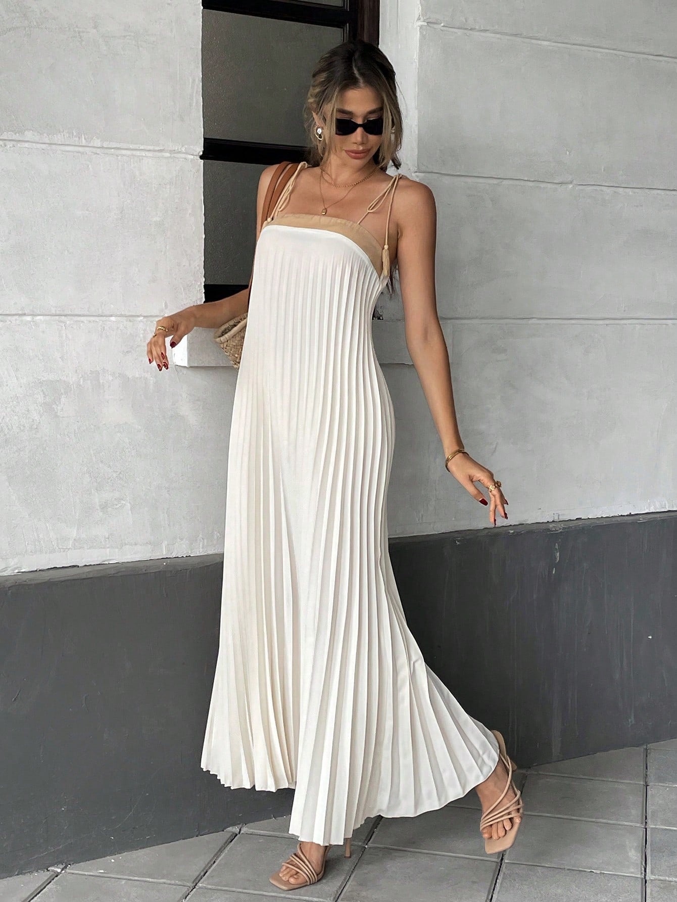 Unleash your inner fashionista with our Chic Pleated Tassel Strap Dress - the perfect addition to your vacation wardrobe! With its trendy tassel straps and flattering pleated design, this dress will have you standing out from the crowd. So why wait? Grab one now and get ready to slay!