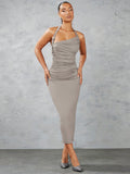 Get ready to turn heads in this Chic Solid Color Ruched Halter Neck Bodycon Dress! Featuring a stylish decorative buckle, this dress hugs your figure in all the right places. The halter neck adds a touch of elegance while the ruched detailing accentuates your curves. Perfect for a night out, this dress is both chic and playful.