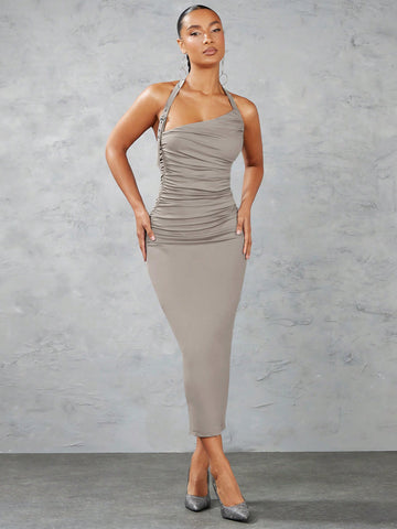 Get ready to turn heads in this Chic Solid Color Ruched Halter Neck Bodycon Dress! Featuring a stylish decorative buckle, this dress hugs your figure in all the right places. The halter neck adds a touch of elegance while the ruched detailing accentuates your curves. Perfect for a night out, this dress is both chic and playful.