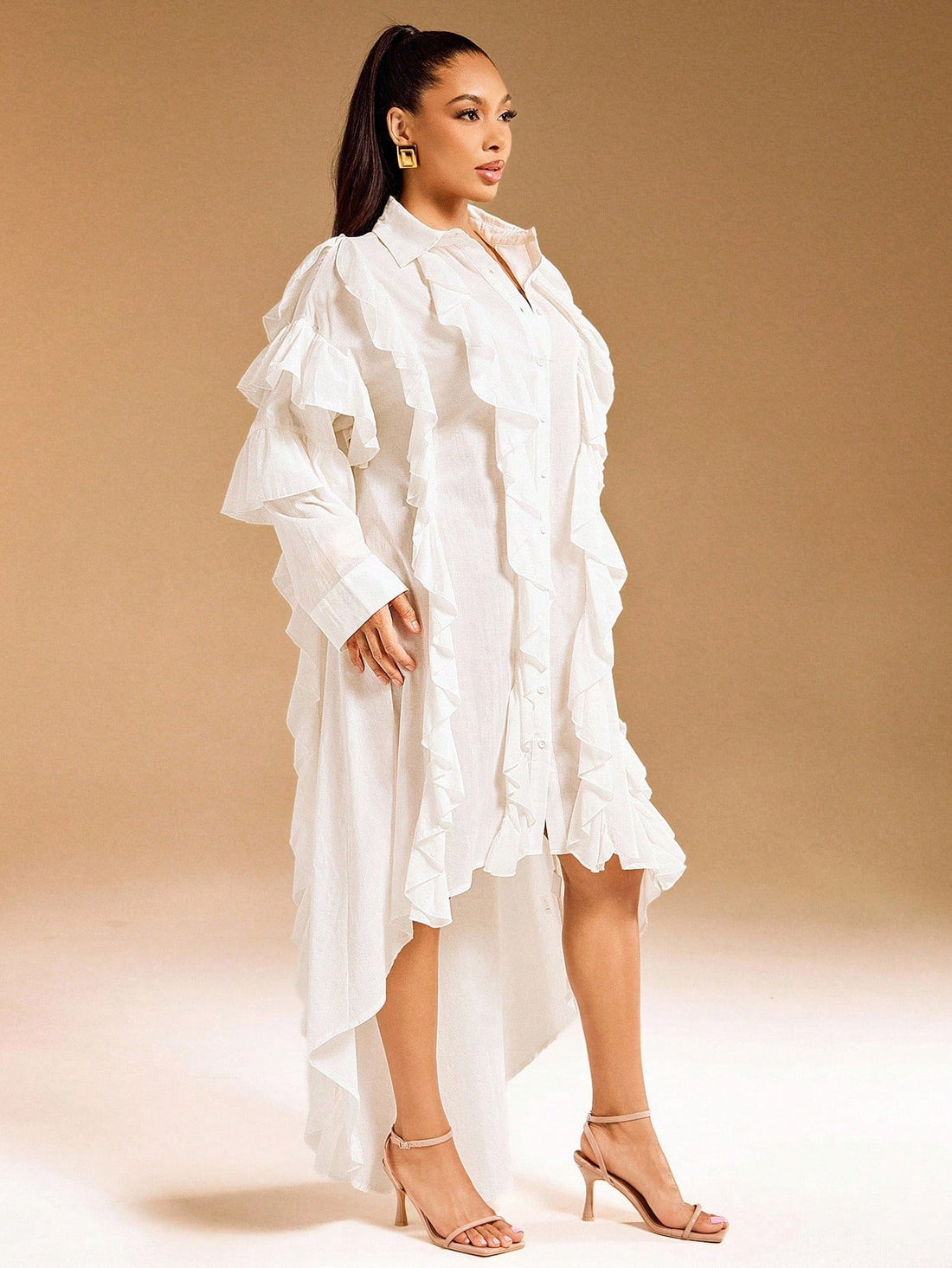 Elevate your everyday wardrobe with this charming shirt dress that effortlessly transitions from brunch to dinner. Crafted from quality woven fabric, it features a crisp button-up collar, playful ruffle detailing, and a flattering hi-low hemline that keeps things interesting. The solid color makes it a versatile closet staple that pairs beautifully with sneakers, sandals, or heels. Dress it up or down—this piece is your new go-to for looking put-together without trying too hard.