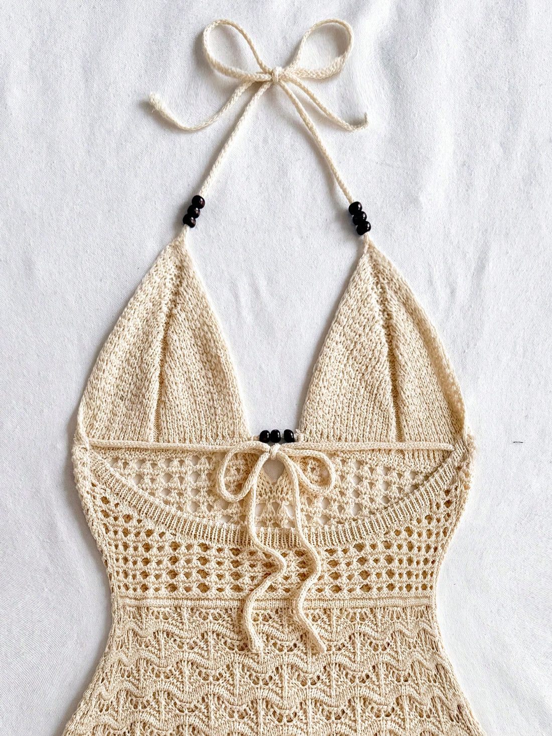 Get ready to be the envy of everyone at your next vacation or festival with this chic and playful bodycon dress! The spaghetti straps and wooden bead details add a touch of flair to this perfect summer dress! (Warning: may cause excessive compliments and head-turning.)