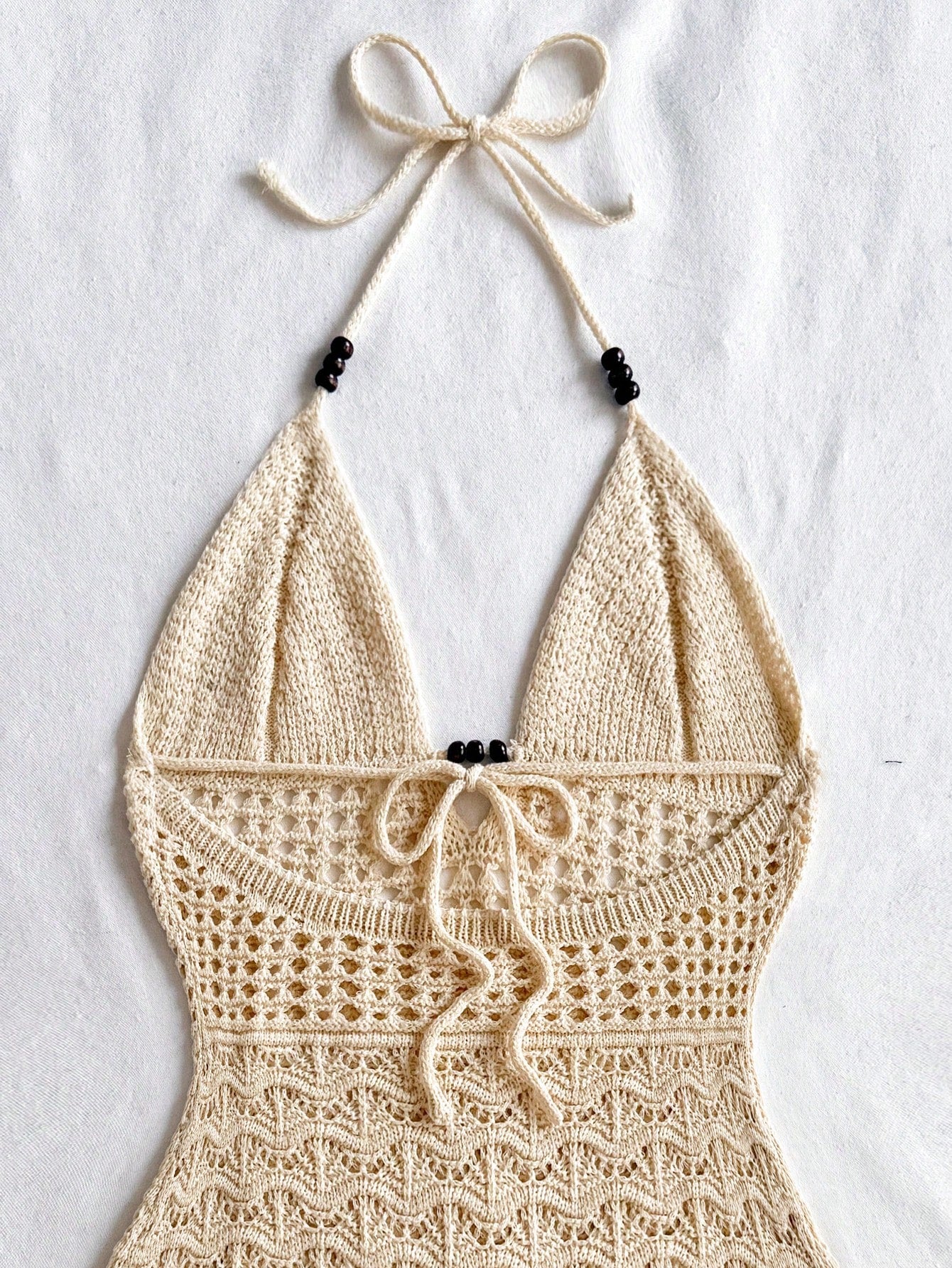 Get ready to be the envy of everyone at your next vacation or festival with this chic and playful bodycon dress! The spaghetti straps and wooden bead details add a touch of flair to this perfect summer dress! (Warning: may cause excessive compliments and head-turning.)