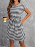 Add a touch of chic to your spring wardrobe with this cinched waist casual dress featuring playful stripes and convenient pockets. Flatter your figure and stay stylishly comfortable all day. Perfect for any occasion. Who says you can't have it all?