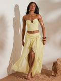 Front full view of light yellow ruched bandeau top and high-slit mesh maxi skirt two-piece set for beach vacation styling