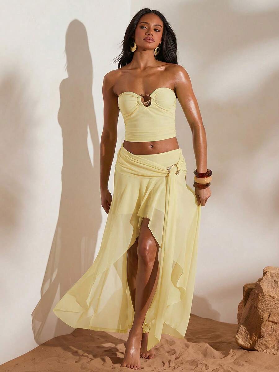 Front full view of light yellow ruched bandeau top and high-slit mesh maxi skirt two-piece set for beach vacation styling