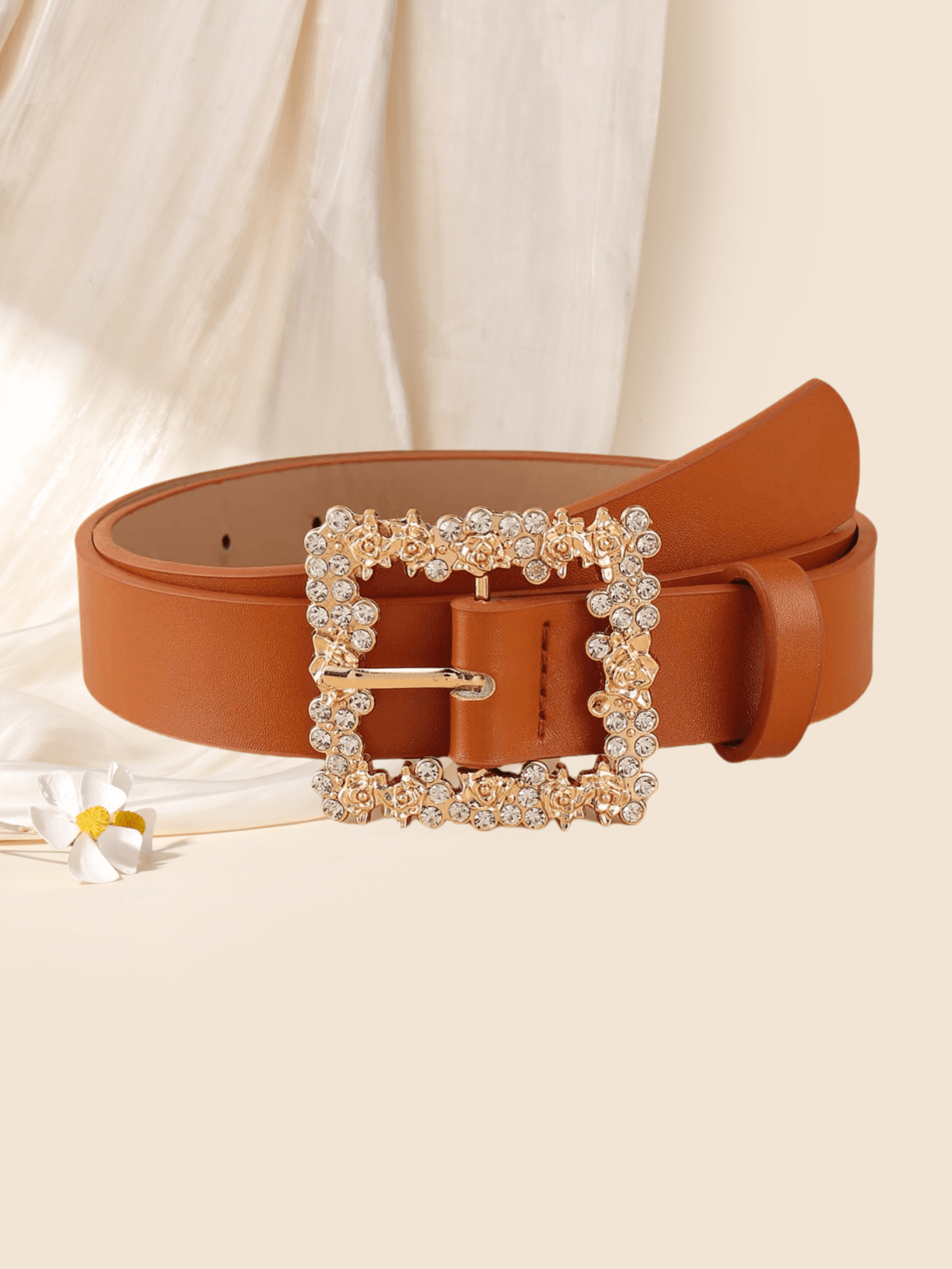 This chic fashion belt for women features a square flower rhinestone buckle that adds a touch of elegance to any outfit. Versatile and stylish, it pairs well with both casual and formal attire. Show off your fashion expertise with this must-have accessory.