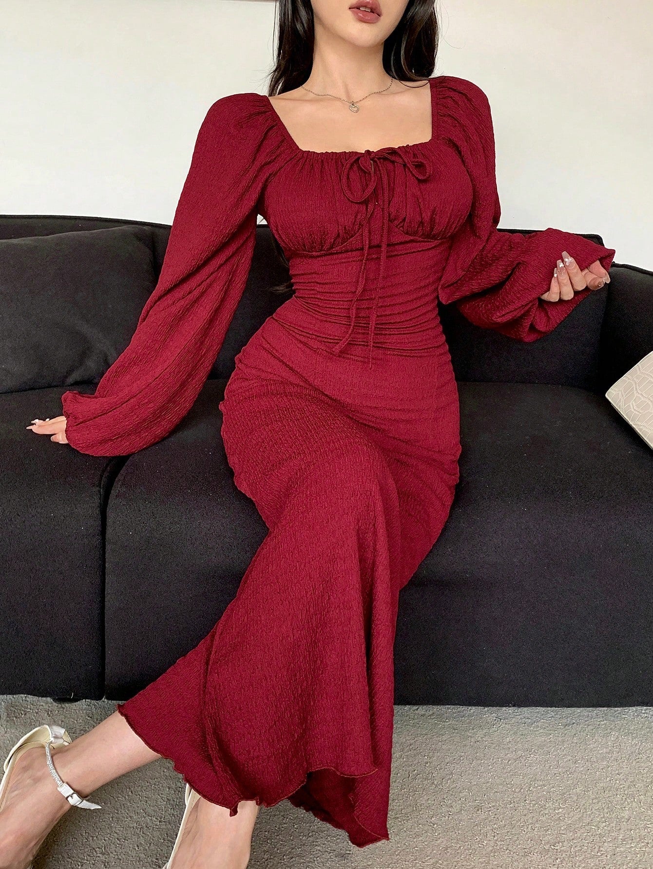 Effortlessly elegant, this dress features a chic square neck and ruched tie-front details. With long sleeves, it's perfect for cooler weather and adds a touch of sophistication to any outfit. Get ready to turn heads in this stylish and versatile dress!