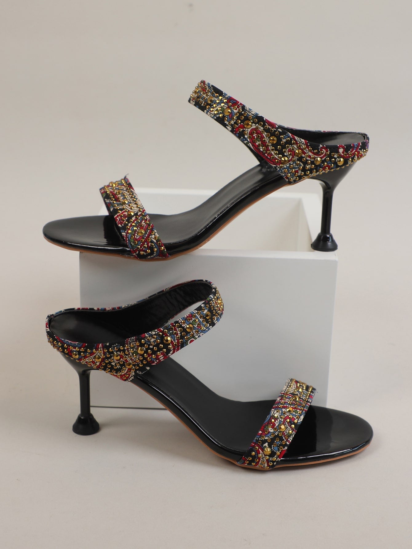 Elevate your style with our Chic Studded Color Block Stiletto Heeled Mule Sandals. These statement shoes feature a unique color block design and stud detailing, adding a touch of edginess to any outfit. With a sturdy stiletto heel, they provide both fashion and comfort for any occasion.