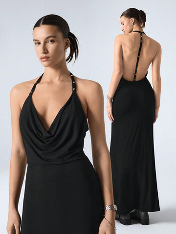 Turn heads in this playful yet elegant maxi dress featuring a chic studded halter neckline and a daring backless design. The mermaid hem adds a flirty flair, perfect for dancing the night away or making a statement at your next special event. Embrace your confidence and let your style shine!
