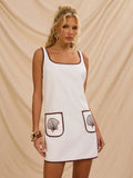 Step into summer fun with this playful A-line mini dress featuring a flattering square neckline and charming embroidered shell details. Its breezy silhouette keeps you cool while adding a touch of seaside whimsy to your look. Perfect for sunny days and spontaneous adventures, this dress brings effortless style and a splash of personality to your warm-weather wardrobe.