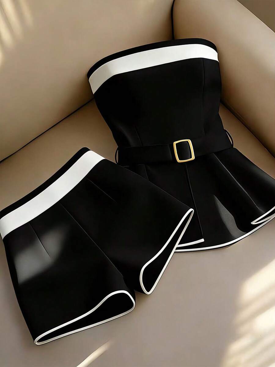 Elevate your summer wardrobe with this sophisticated 2-piece set designed for the modern commuter. The strapless bandeau top features elegant contrast binding and an asymmetrical cut, paired with a sleek mini shorts in a timeless colorblock design. The belted silhouette creates a polished, office-ready look that transitions seamlessly from desk to evening plans. Crafted from a premium 95% polyester and 5% elastane blend, this set offers a slim fit with a semi-sheer finish for an understated elegance. 