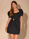 Full front view of black puff sleeve mini dress with square neckline and gold-tone waist ornament