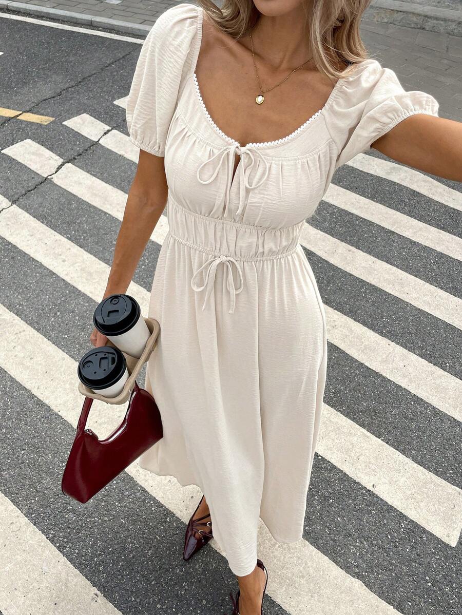 Step into summer with this playful and chic casual dress featuring puff sleeves and a trendy tie-front detail. Its solid color design makes it easy to mix and match, while the flattering silhouette keeps you comfortable and stylish all day long. Perfect for sunny days, brunch dates, or casual outings, this dress adds a fun, flirty touch to your warm-weather wardrobe.