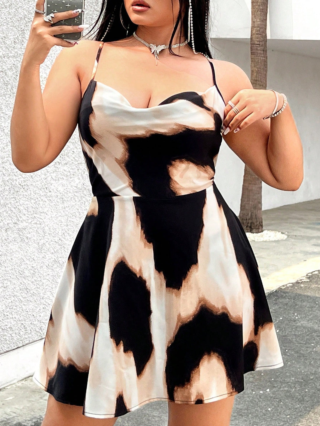 Enhance your summer wardrobe with Chic Summer Vibes: Plus Size Tie-Dye Backless Cami Dress. The chic tie-dye design and backless style exude effortless style, perfect for any summer occasion. Plus, the comfortable fit in a range of sizes ensures you'll feel confident and chic at the same time. Elevate your summer vibes today.