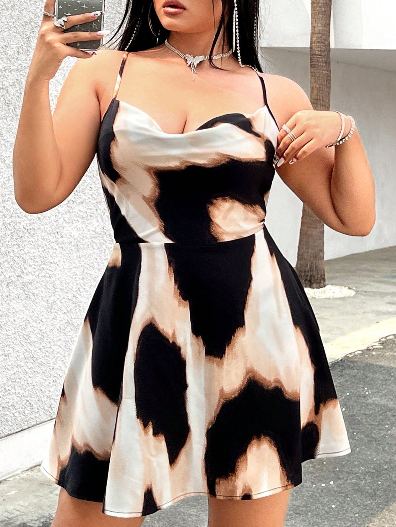Enhance your summer wardrobe with Chic Summer Vibes: Plus Size Tie-Dye Backless Cami Dress. The chic tie-dye design and backless style exude effortless style, perfect for any summer occasion. Plus, the comfortable fit in a range of sizes ensures you'll feel confident and chic at the same time. Elevate your summer vibes today.
