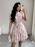Elevate your vacation wardrobe with this chic tie-dye floral dress. Featuring a romantic stand collar, button-front closure, and flattering puff sleeves, this A-line silhouette offers effortless elegance. The high-waist design with belt detail creates a polished look, while the flared hem adds movement and grace. Crafted from 100% polyester woven fabric in a vibrant multicolor palette, it's perfect for getaways and special occasions. Regular fit, short length. Hand wash for easy care.