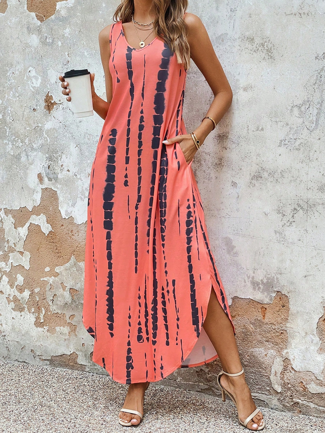 Add some fun and convenience to your wardrobe with our Chic Tie-Dye Maxi Dress! This dress features a stylish split hem, perfect for twirling, and hidden pockets for storing all your essentials. The vibrant tie-dye design adds a playful touch to any outfit.