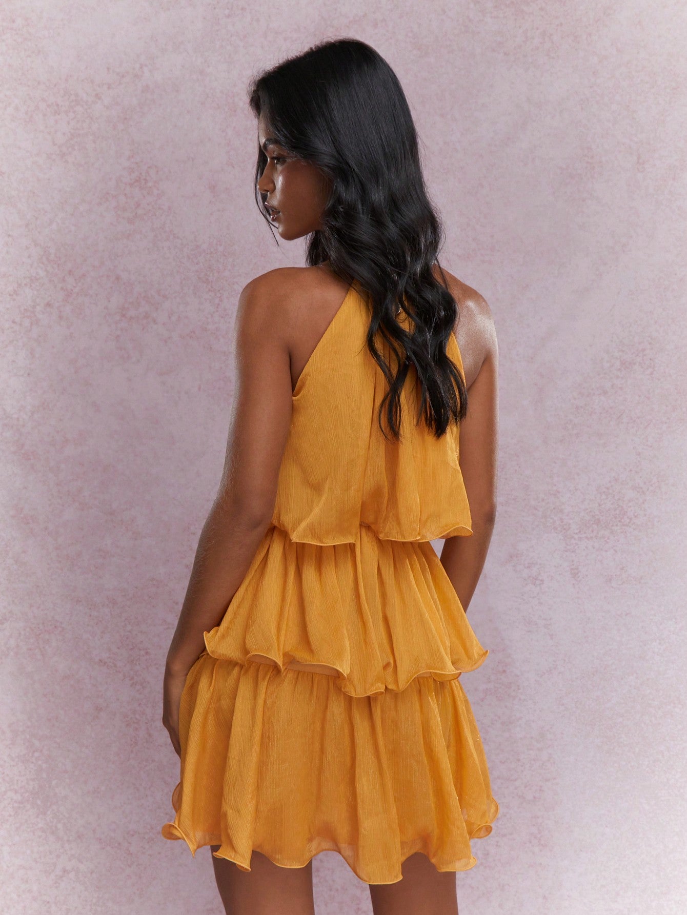 Effortlessly exude elegance in our Chic Tiered Ruffle Halter Neck Mini Dress. The tiered ruffle design and halter neckline create a chic and stylish look. Perfect for any occasion, this dress is the epitome of effortless elegance.