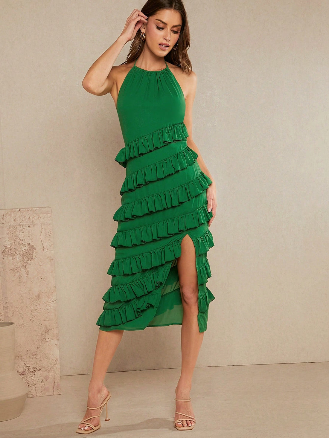 Step into summer with this playful tiered ruffle halter dress, designed for easy elegance. The split detail adds a flirty twist, while the tie halter neckline lets you adjust for the perfect fit. Lightweight and breezy, it’s your go-to for sunny days and spontaneous adventures.