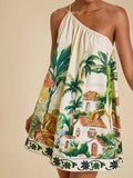 Front view of cream and green tropical one-shoulder mini dress with scenic print and border hem