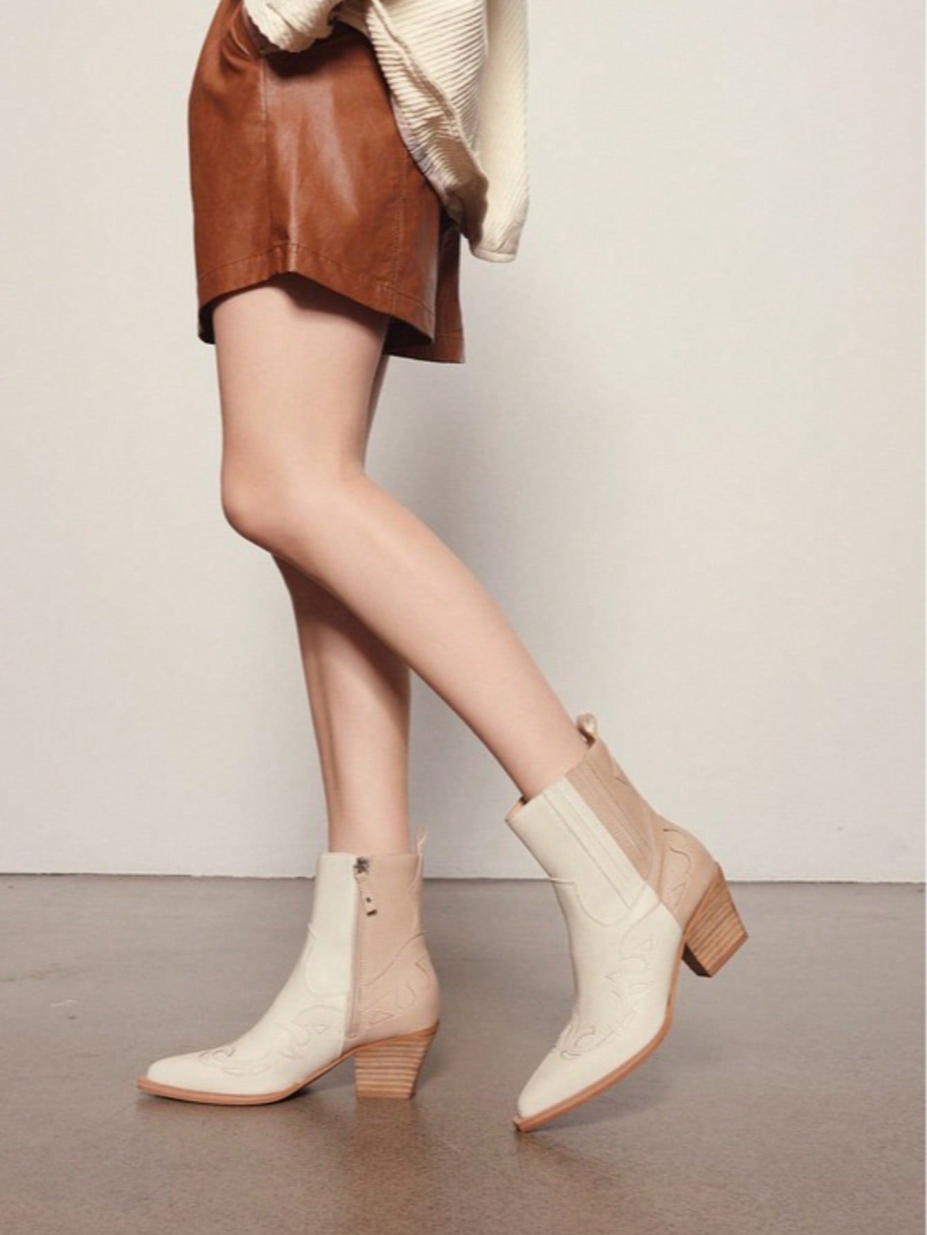 Step out in style with these Chic Two-Tone Western Ankle Boots! Perfect for adding a playful twist to your wardrobe, their eye-catching design blends classic western flair with modern charm. Comfortable and versatile, these boots are ready to accompany you on any adventure, turning heads wherever you go. Embrace your inner trendsetter and let your feet do the talking!