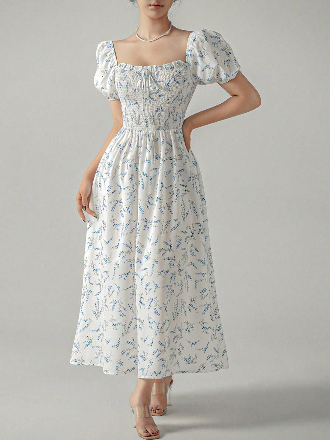 This Chic Unity dress features a dainty ditsy floral print and playful puff sleeves. The front knot detail adds an extra touch of whimsy to this elegant piece. Stay stylish and comfortable with this fashion-forward dress.
