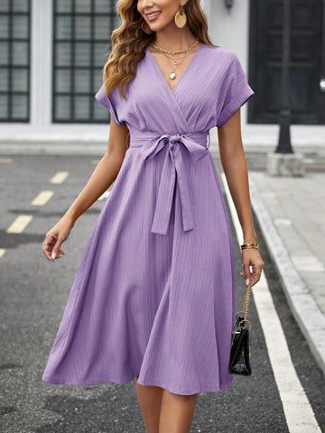 Turn heads in this effortlessly chic V-neck midi dress! With its stylish criss-cross detail and flattering waist belt, you'll exude confidence and style in the workplace. Perfect for all your business casual needs, this dress is a must-have for any fashion-forward professional. (See what we did there?)