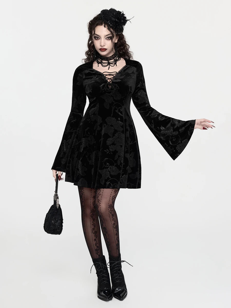 Front view of black velvet rose gothic mini dress with lace-trimmed V neckline and flared sleeves